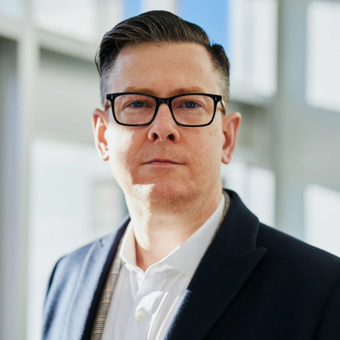 man standing beside wall